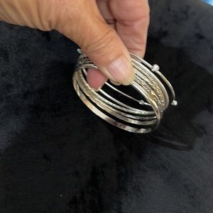 Silver tone bangle bracelets. One w/ faux diamond’s and one w/turquoise like.